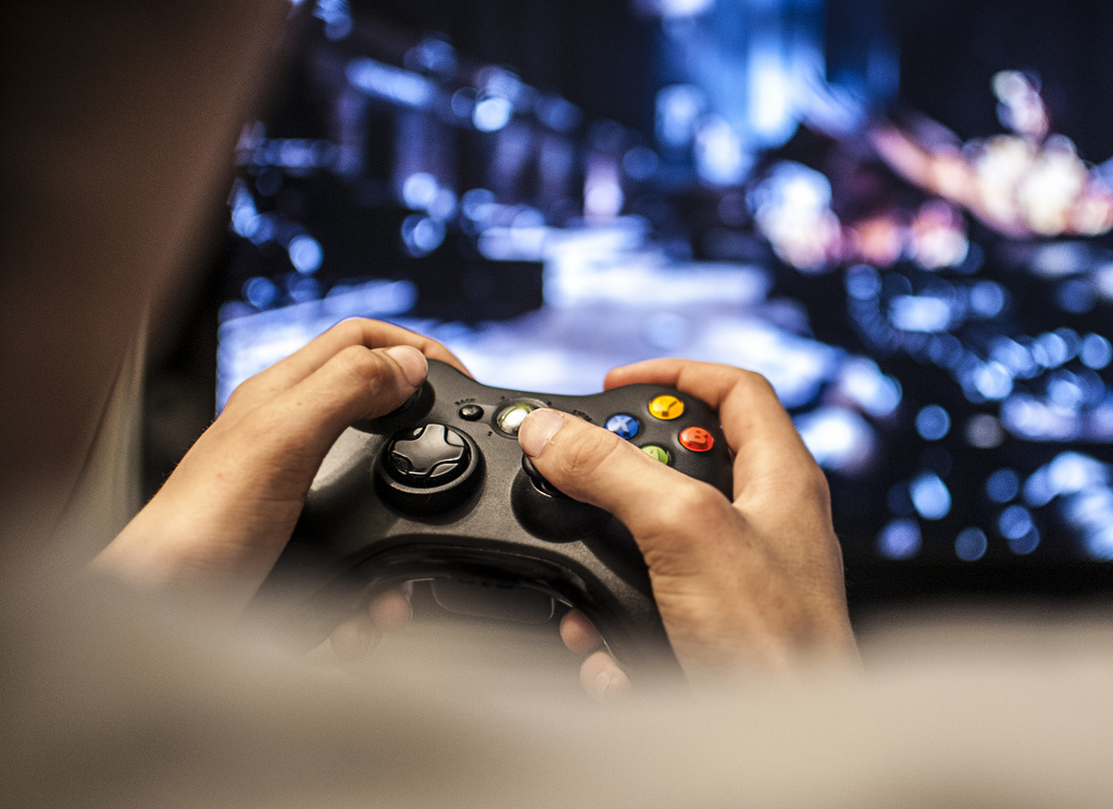 Man playing video games on an Xbox 360
