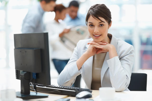 Pretty Caucasian business woman at office desk