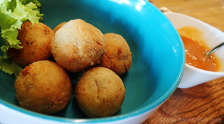 Risotto Balls, P275 Breaded and fried mushroom risotto balls stuffed with mozzarella cheese, served with tomato sauce.