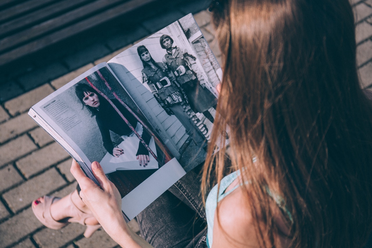 Woman Looking Through Fashion Magazine