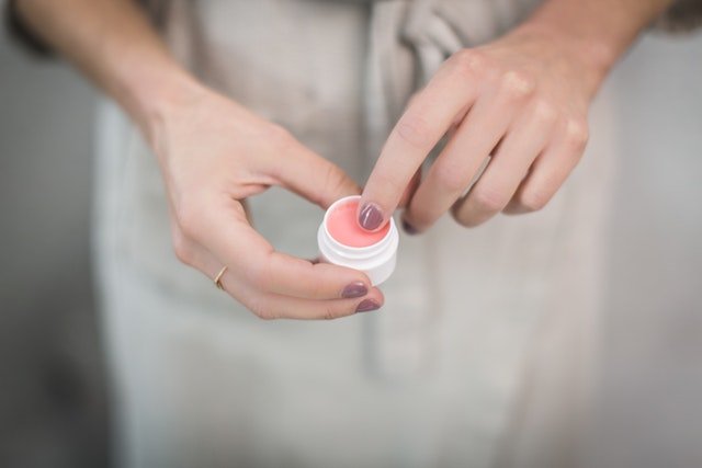 Woman Holding a Lip Balm