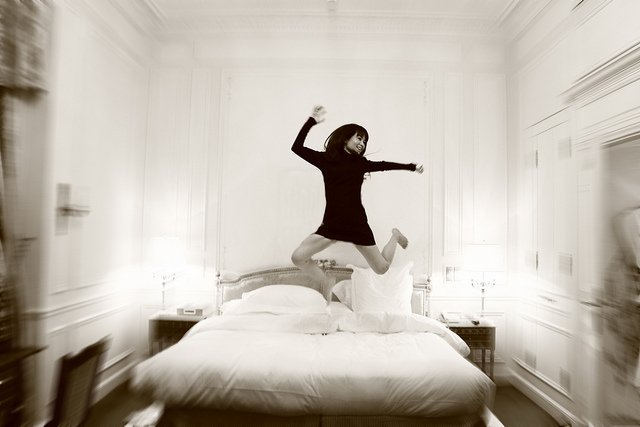 Woman Jumping on Bed