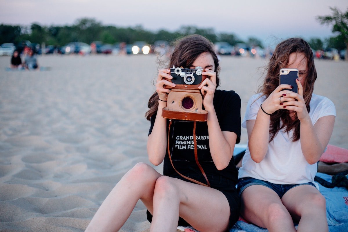 two friends taking a photo of someone