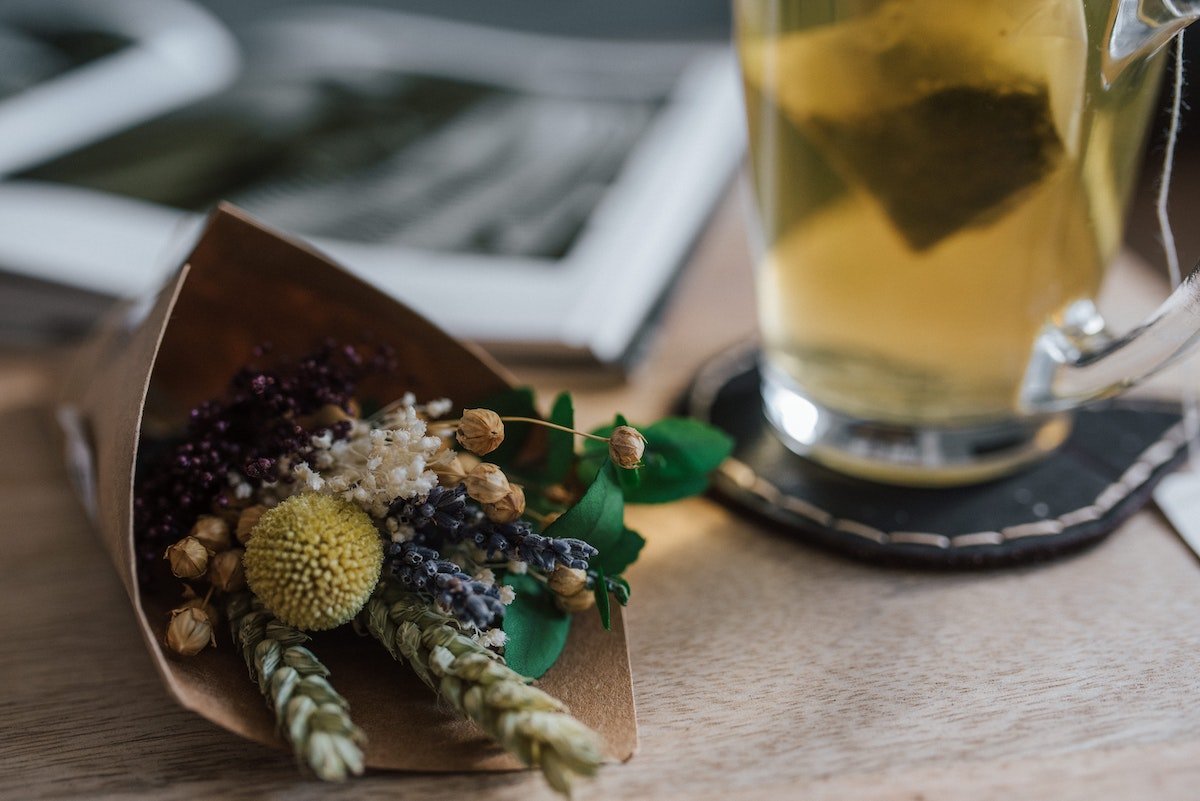 flowers next to a glass of tea