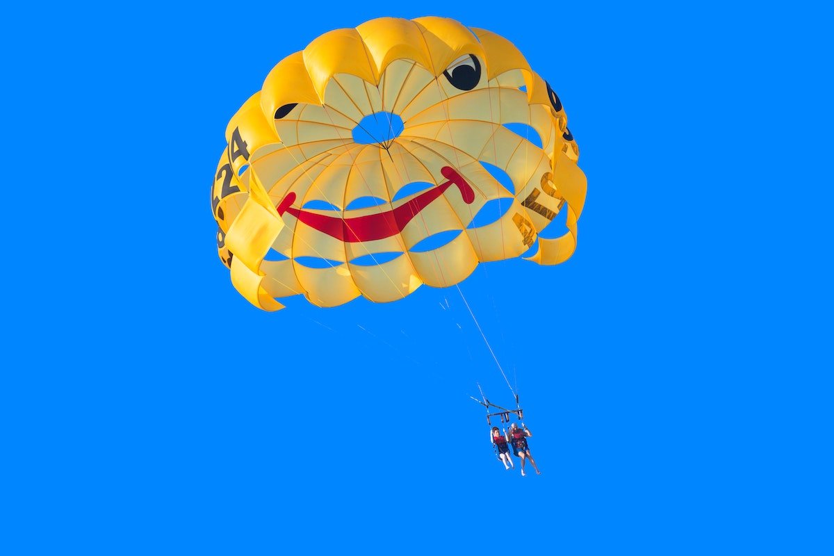 two people with a smiley parachute