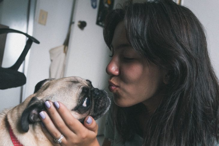 woman kissing her dog