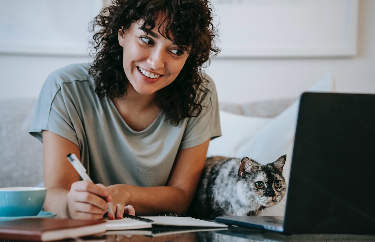 happy woman next to her cat