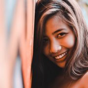 woman leaning against a wall
