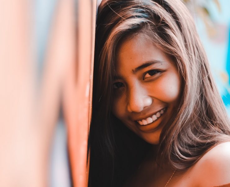 woman leaning against a wall