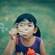 kid playing bubbles