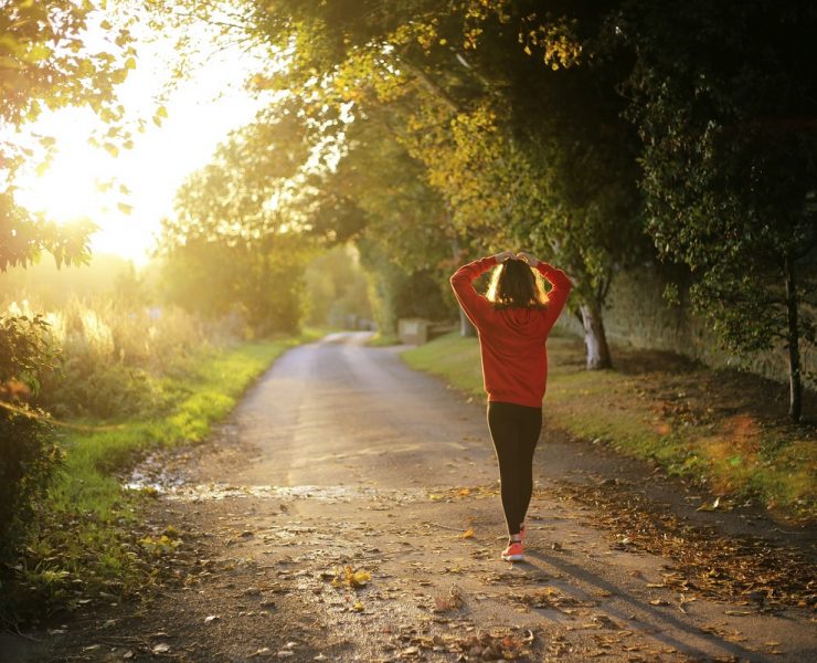 Woman walking on pathway during daytime