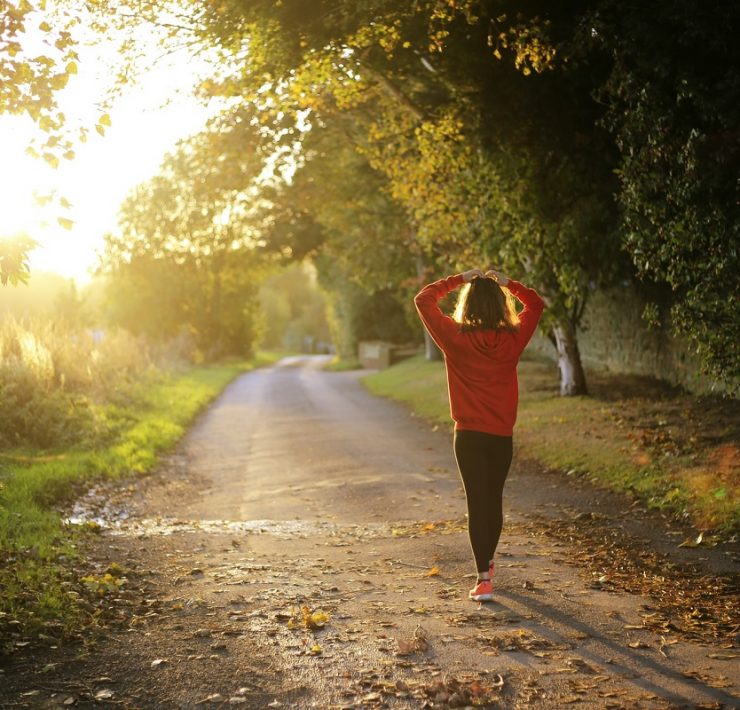 Woman walking on pathway during daytime