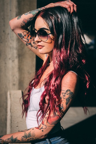 Woman wearing white sando with tattoos