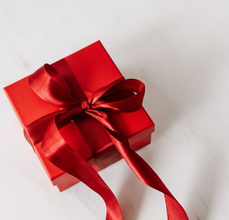 Red gift box tied with ribbon