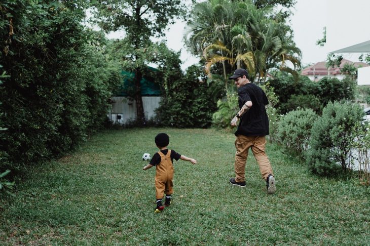 Father and Son Playing Football in the Backyard