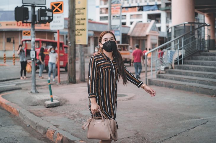 woman with facemask walking on the street