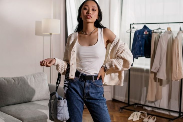 woman in cropped cardigan and jeans