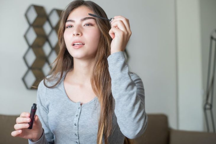 woman applying eyebrow makeup