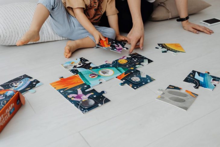 mother and baby finishing a puzzle