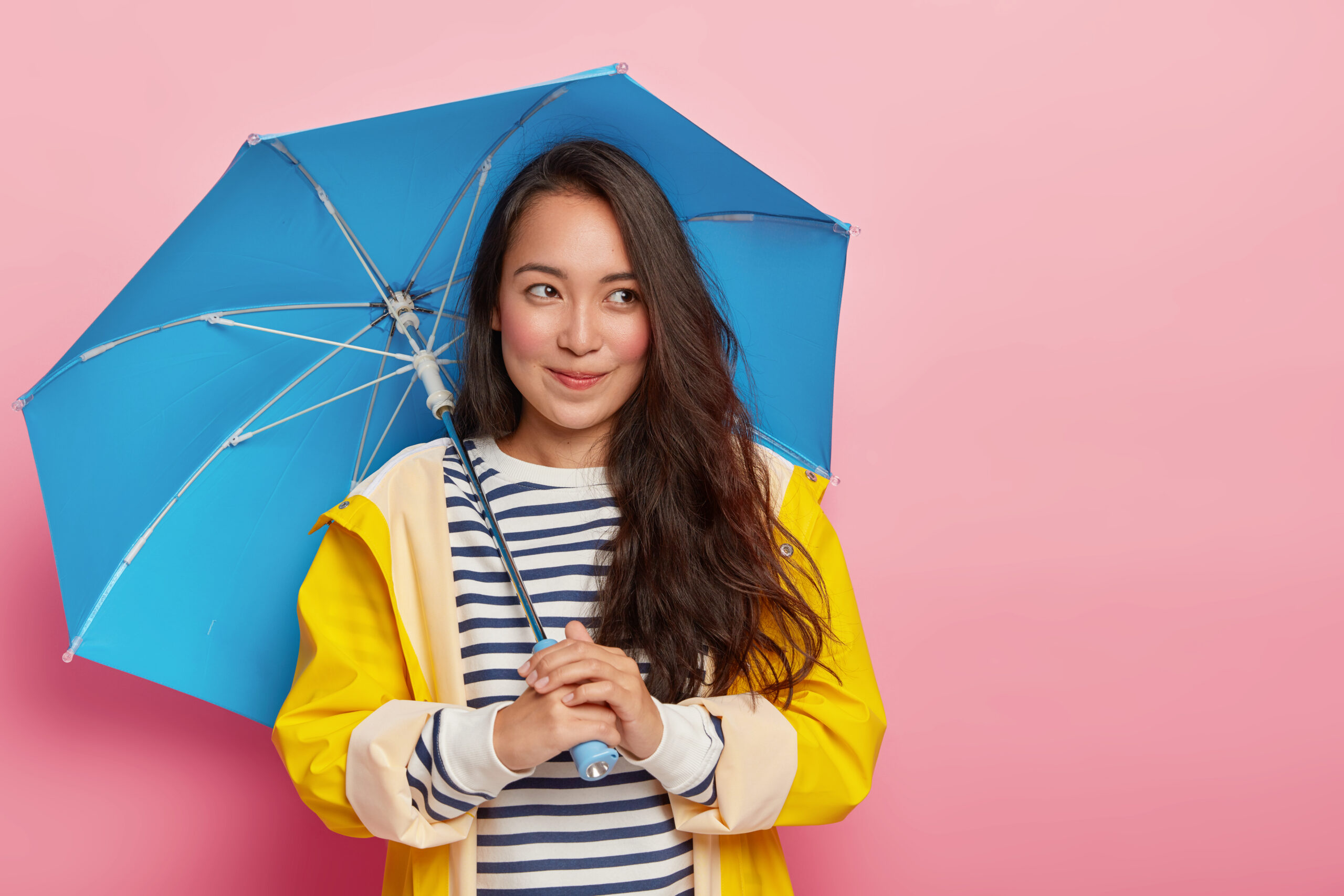 a woman holding a blue umbrella