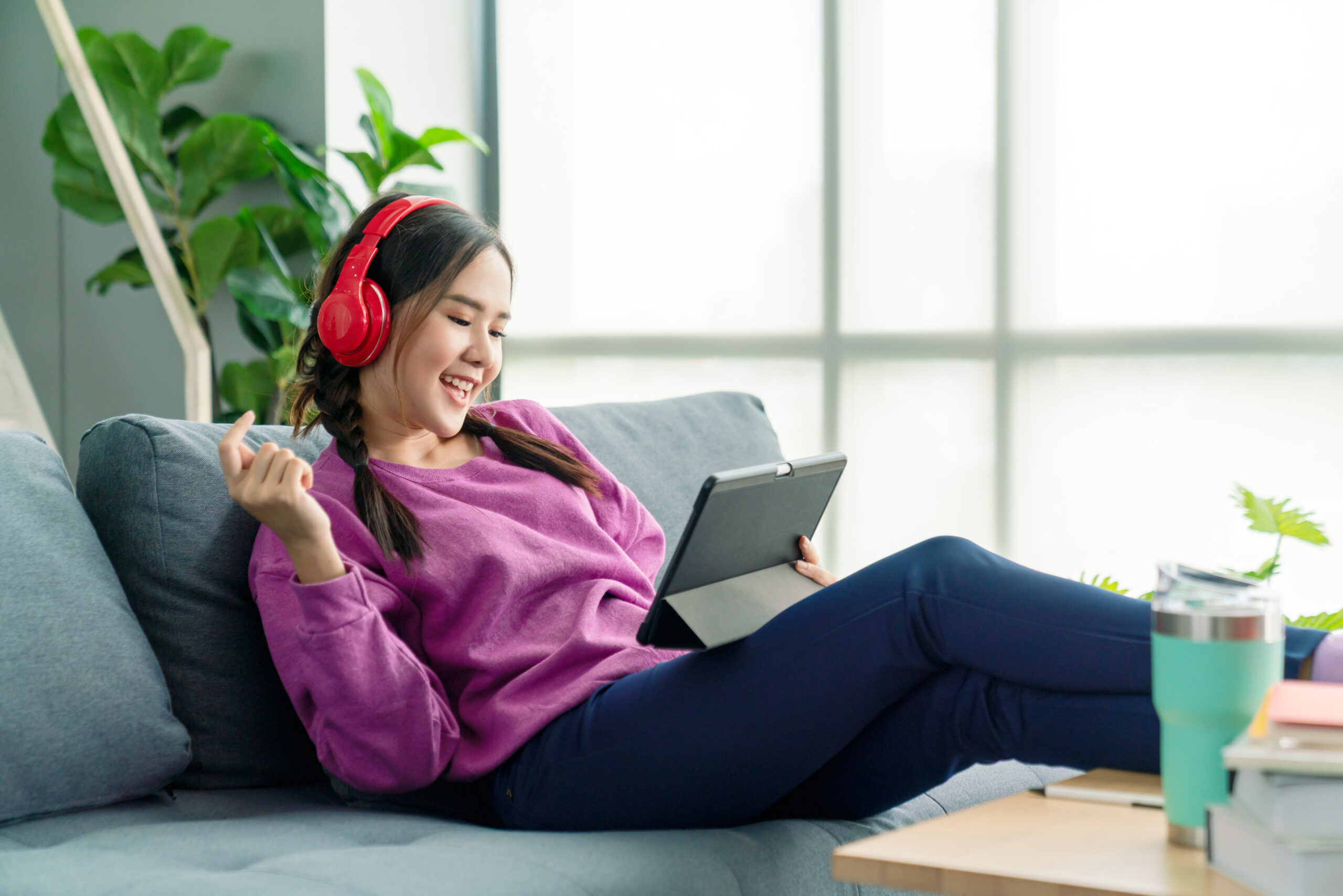 a young woman playing games on her tablet