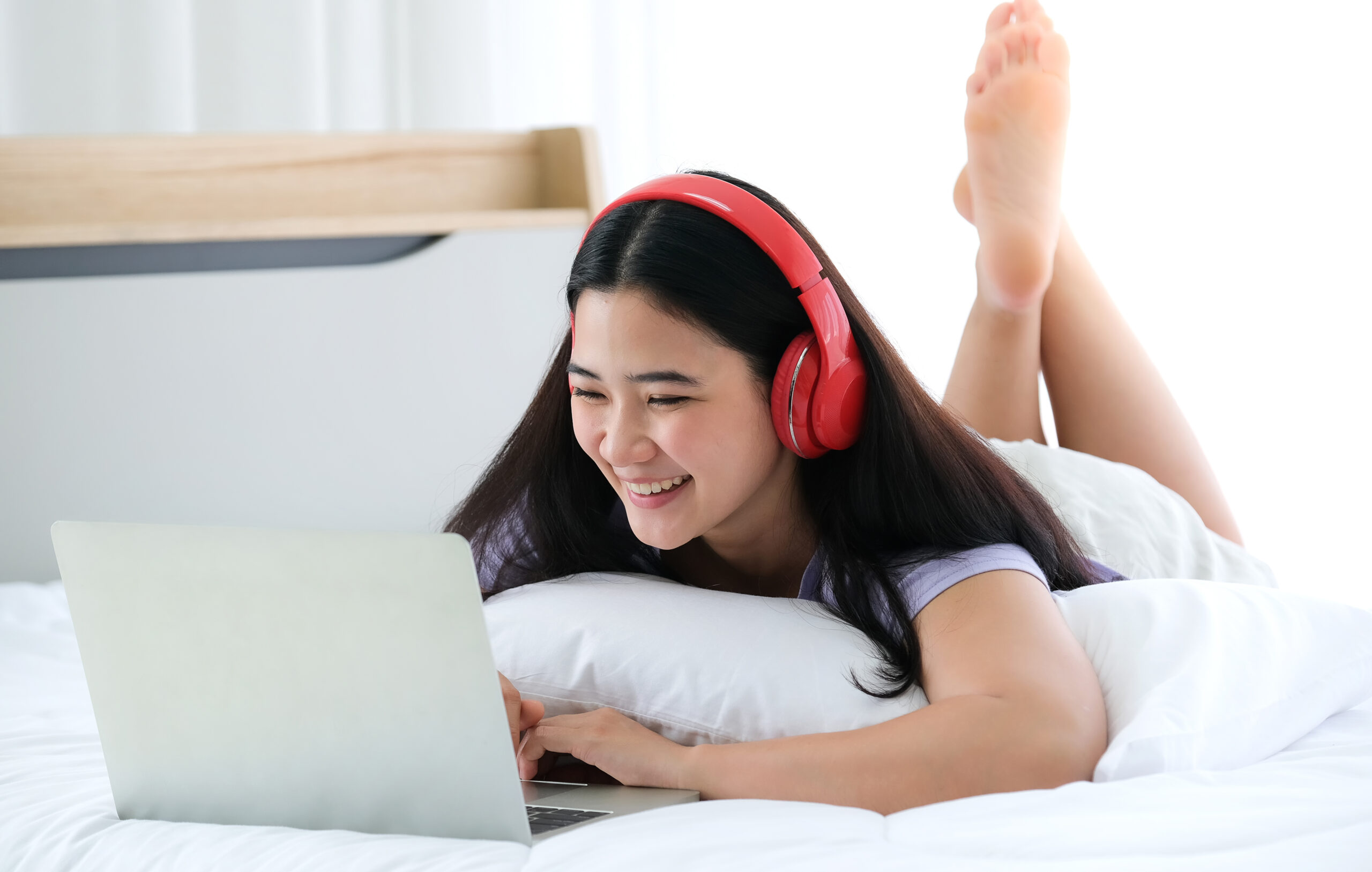 a young woman playing games on her laptop