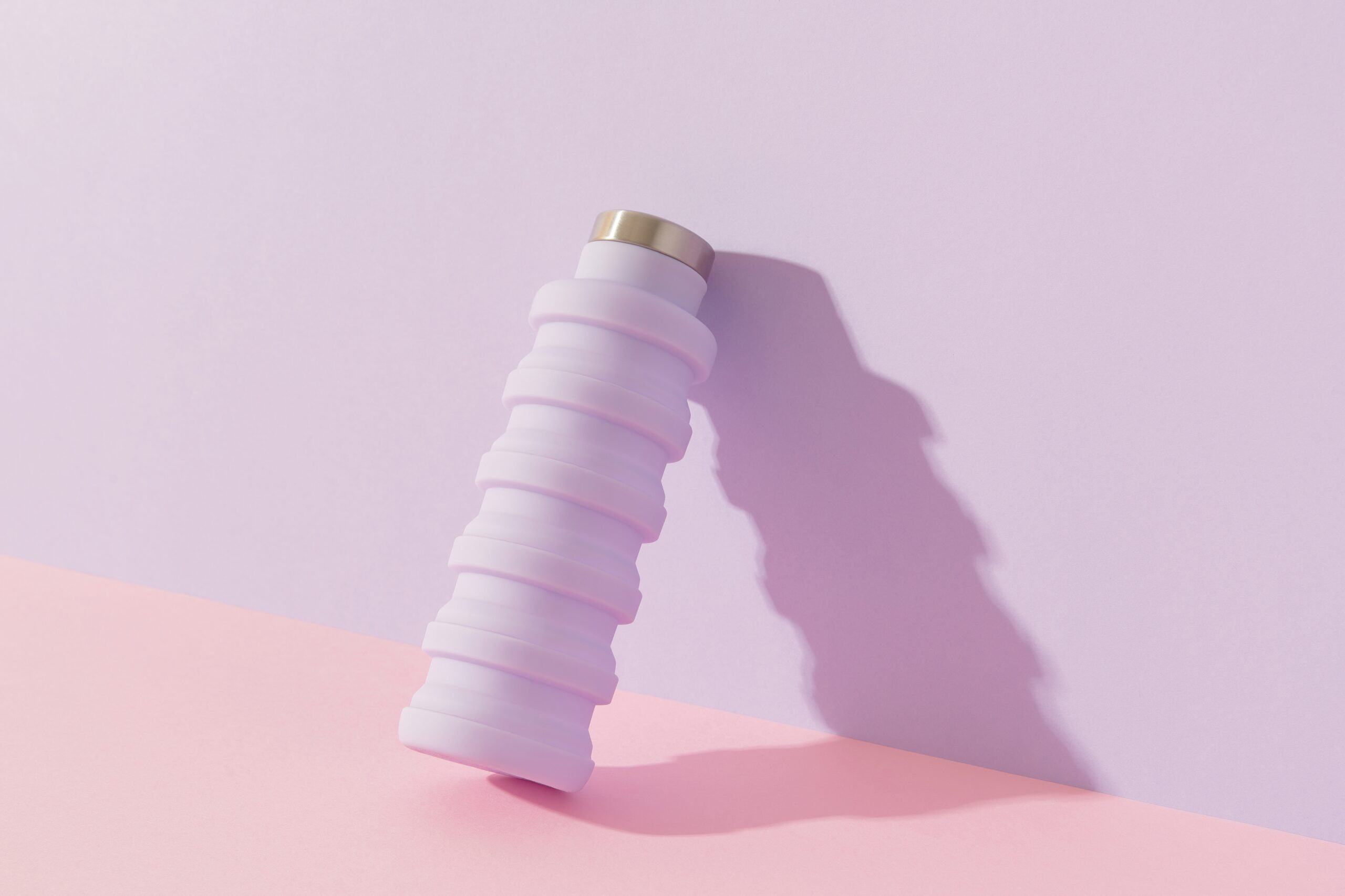 collapsible water bottle on a purple background