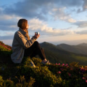 a woman watching the view from a mountain