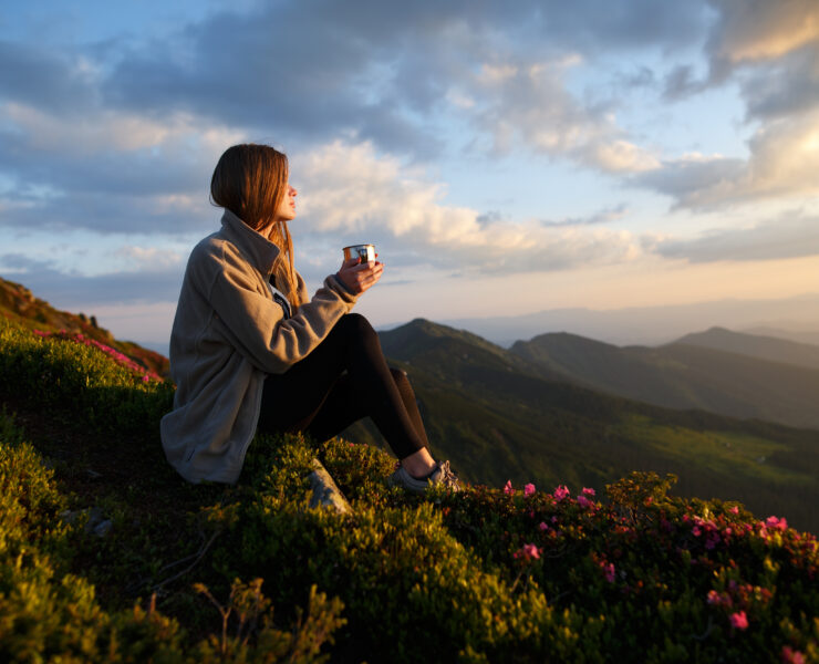 a woman watching the view from a mountain
