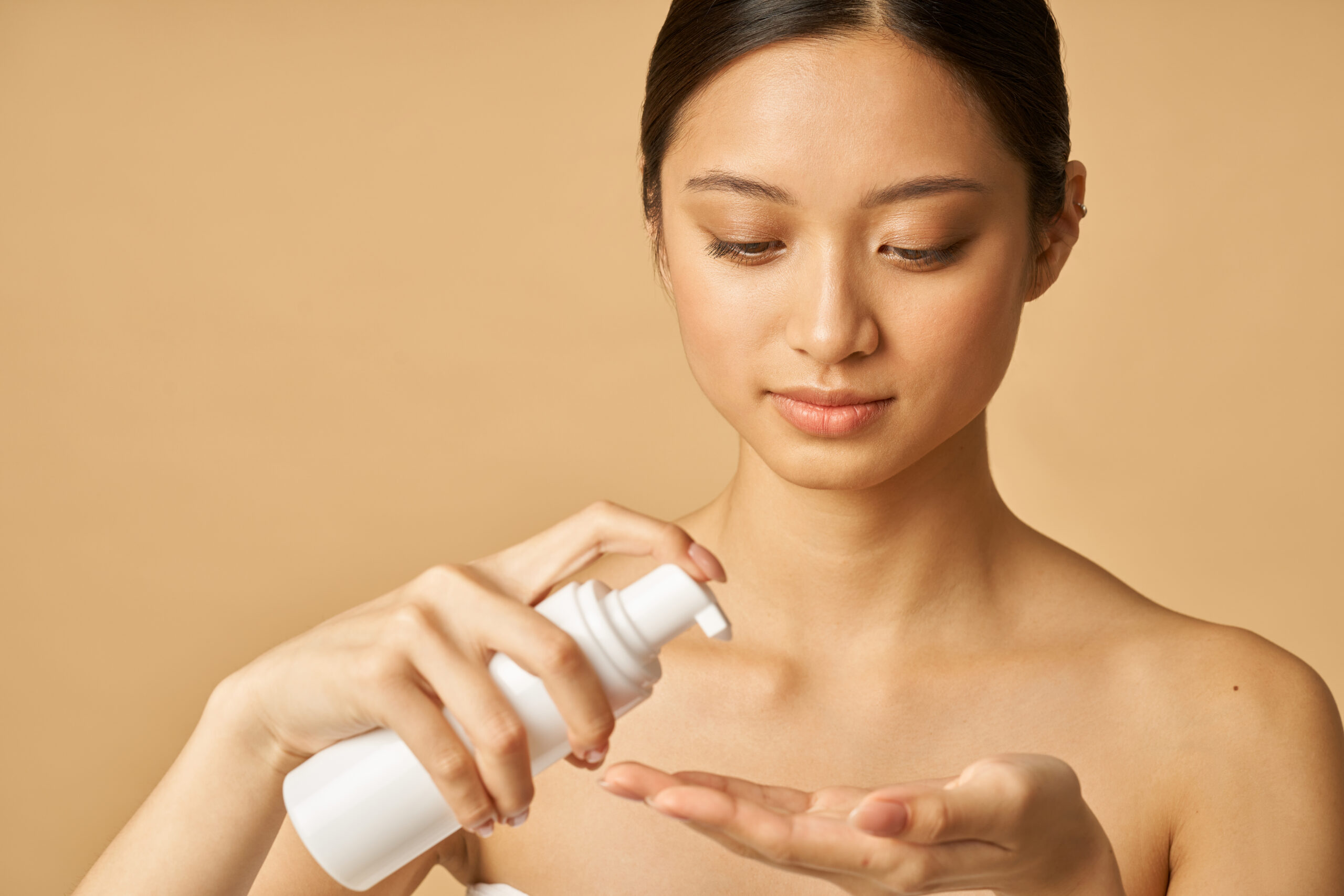 a bare-faced woman putting toner