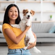 a young woman holding her dog