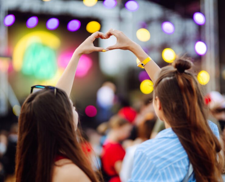 two girls forming a heart