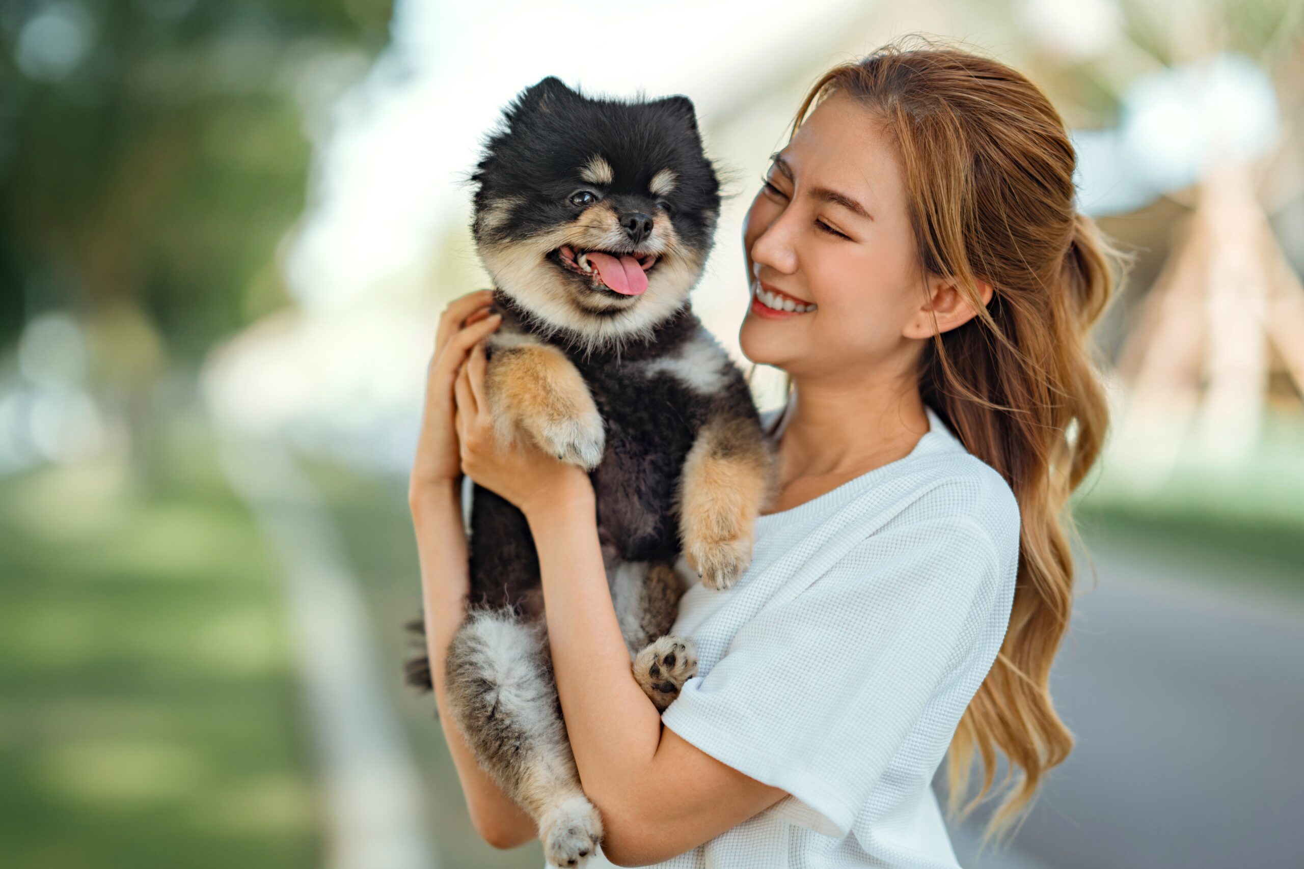 a young woman holding her dog