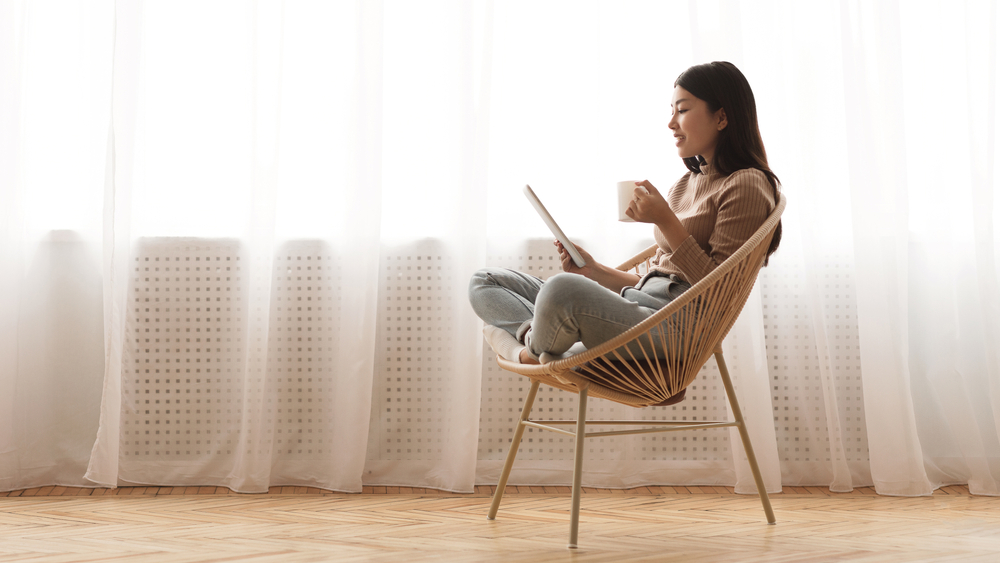 a young woman reading on her e-reader