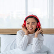 a woman listening a podcast through her headphones