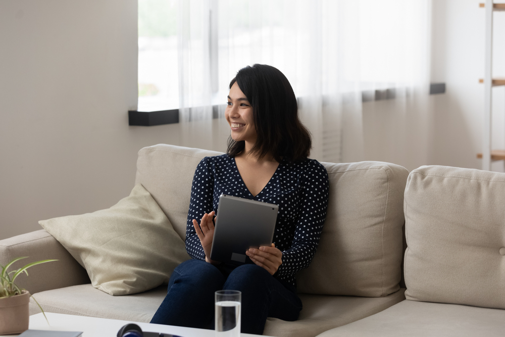 a young woman reading on her e-reader