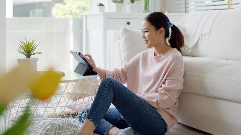 a young woman reading on her e-reader