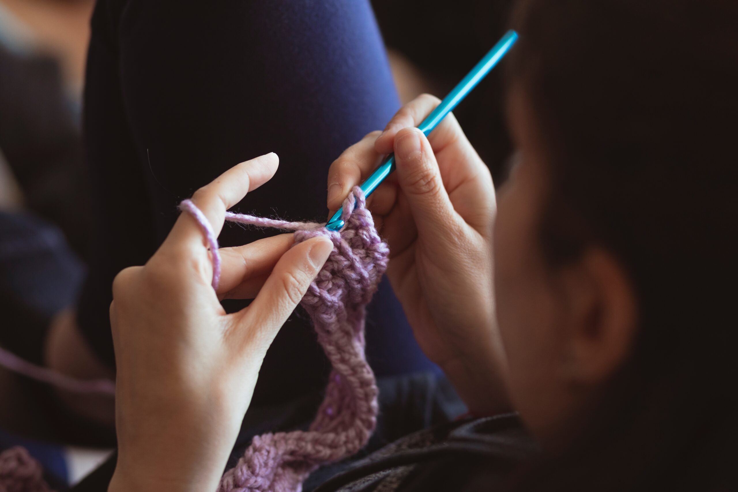 a young woman crocheting