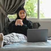 a girl watching a movie on her laptop