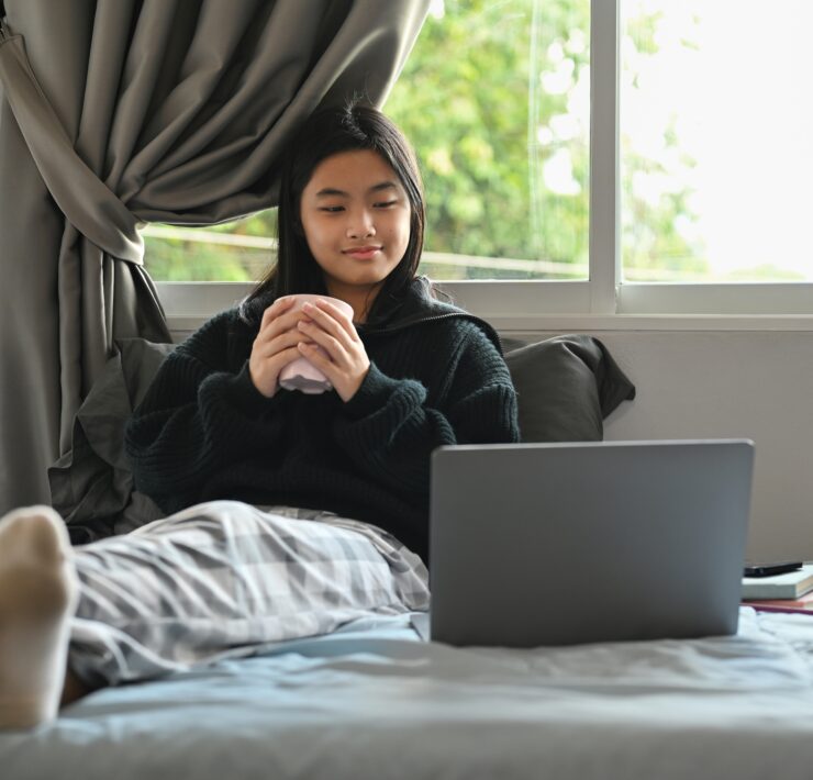 a girl watching a movie on her laptop