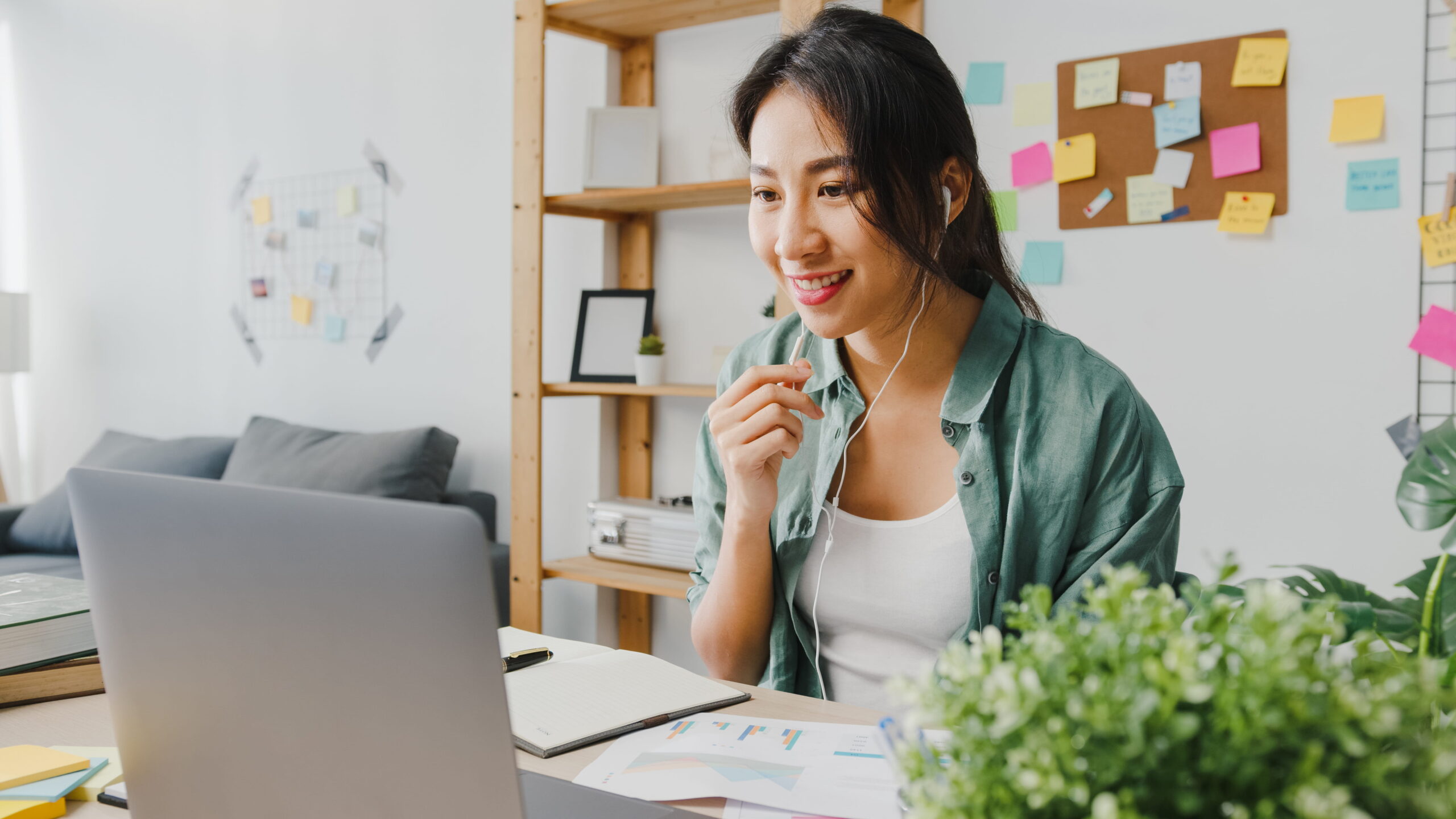 Woman using laptop talk to colleagues in video call while working from home