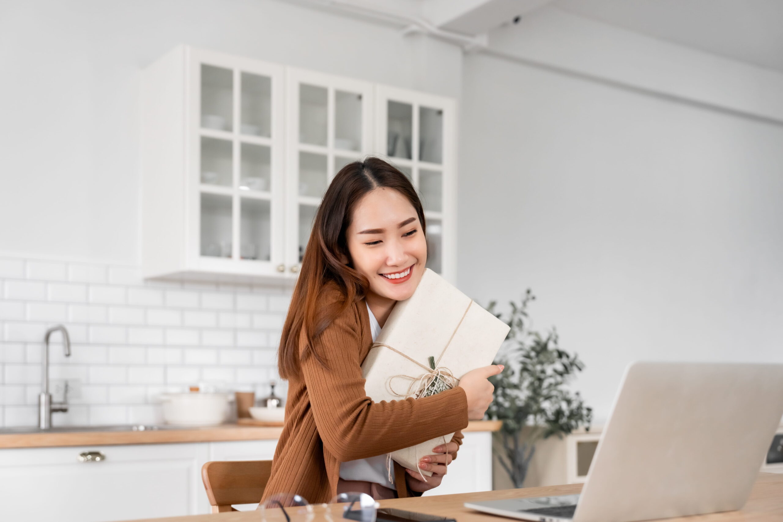 a woman celebrating her birthday holding a gift