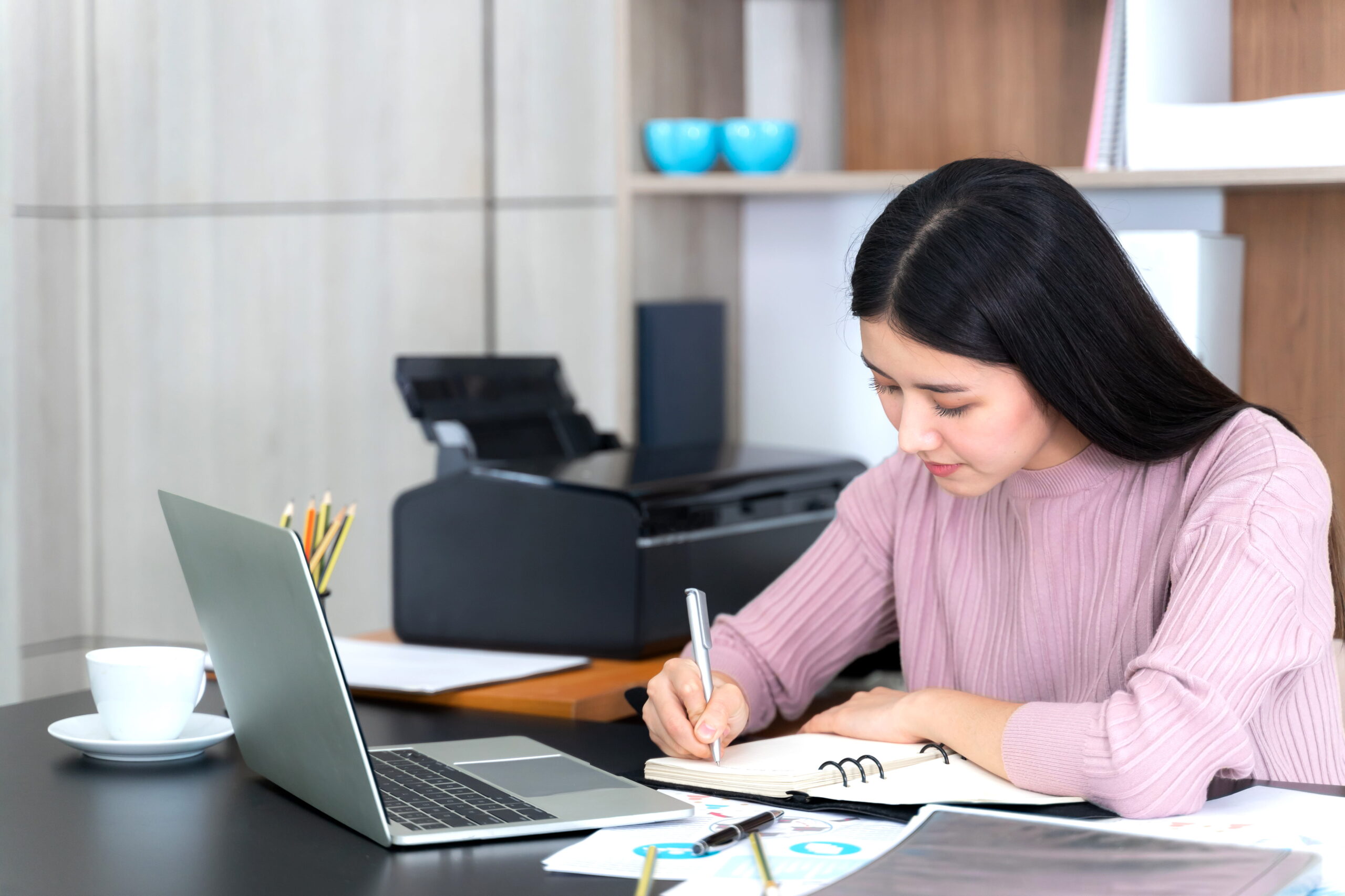 young woman using laptop computer on office desk