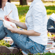 friends doing offline activities while having a picnic