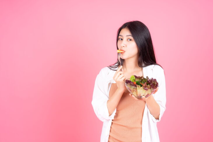 Woman eating fresh salad
