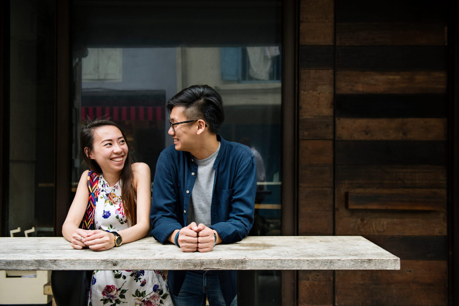 A couple smiling and talking at a table