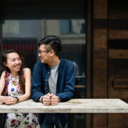 A couple smiling and talking at a table