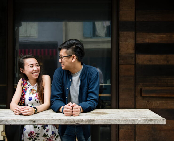 A couple smiling and talking at a table