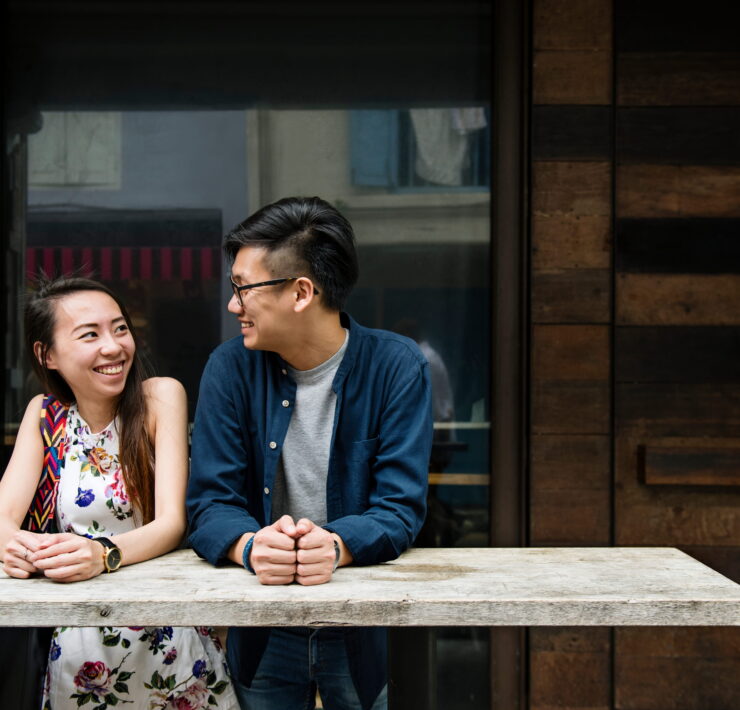 A couple smiling and talking at a table