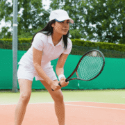 Woman playing tennis in an outdoor tennis court